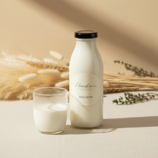 Milk Kefir bottle with square Nourish & Co label on warm cream linen background